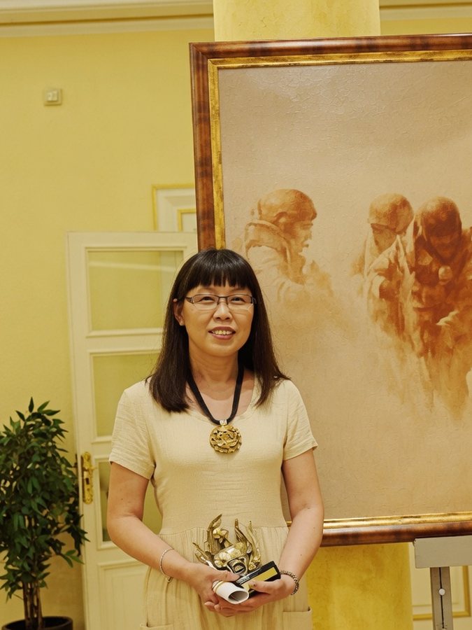 Miao Du junto a una de sus obras